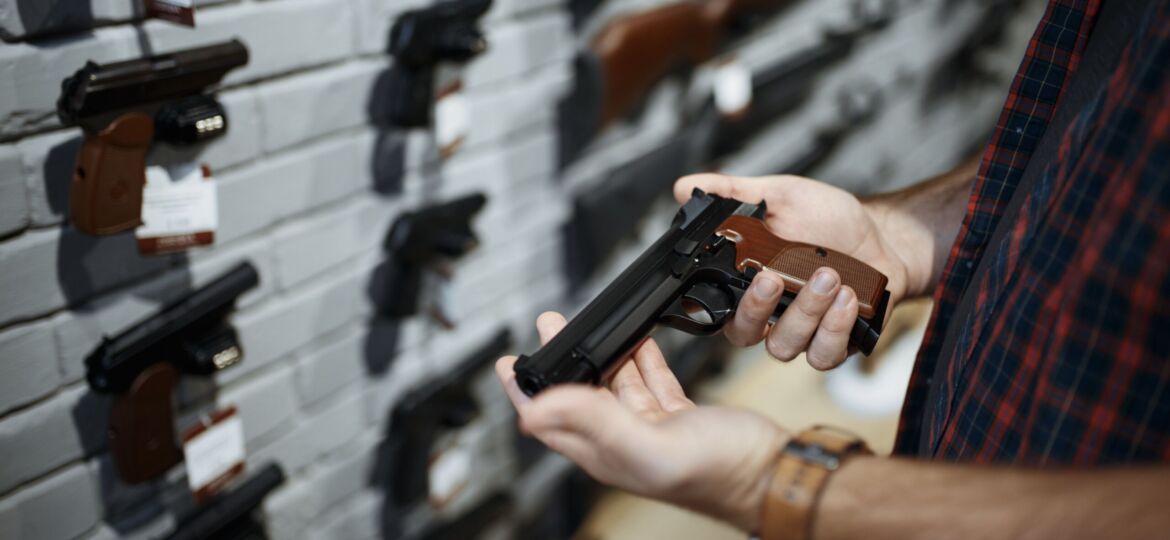 gun-store-handgun-in-hand