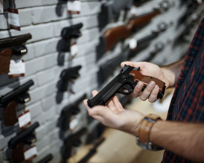 gun-store-handgun-in-hand