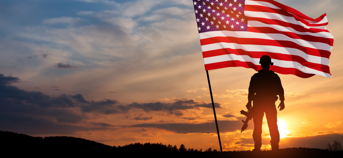 veteran standing by american flag